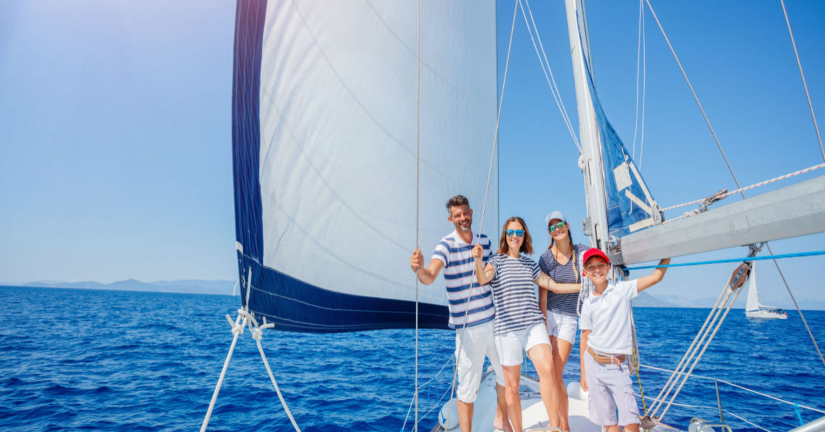 Sailing away family on board yacht