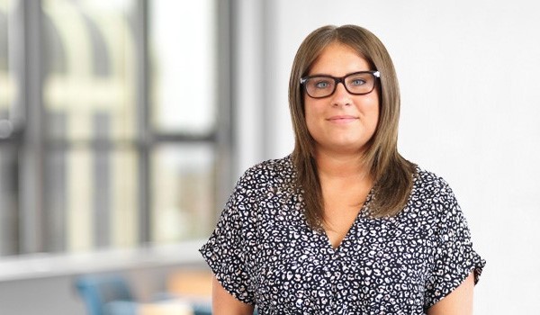 Brodie Ross - lady solicitor with dark hair and spectacles