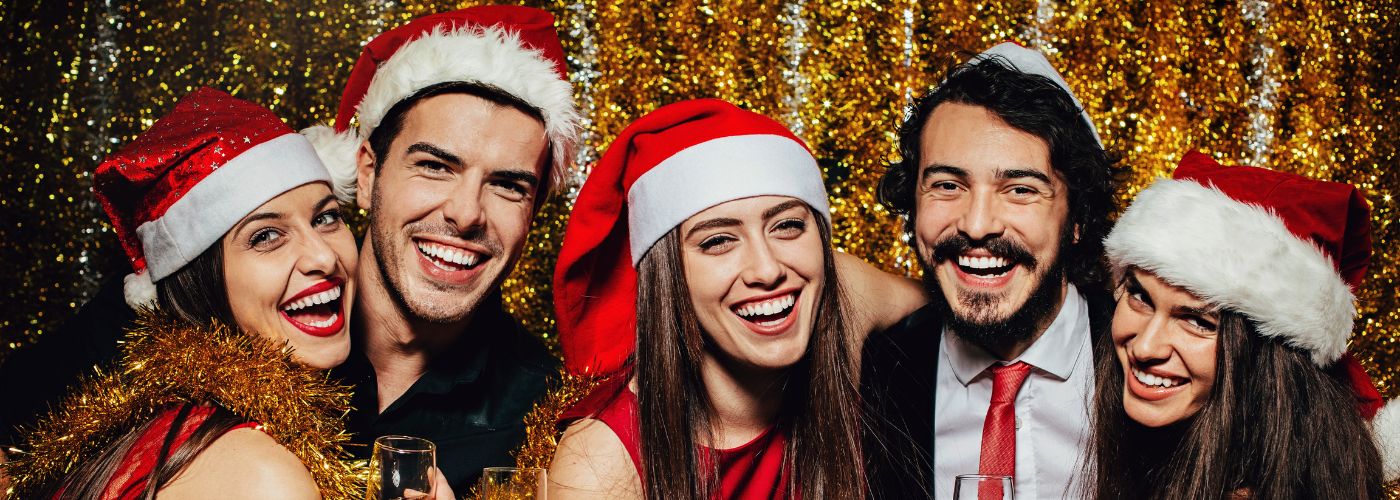 Five people wearing santa hats