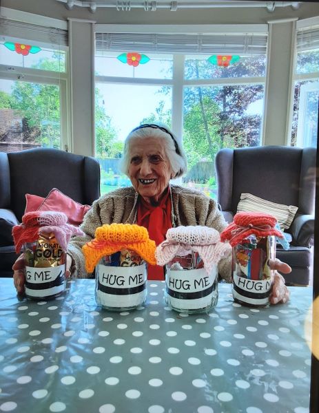 Woodpeckers resident Betty Hampton with her woollen hats for the hug me jars for carers