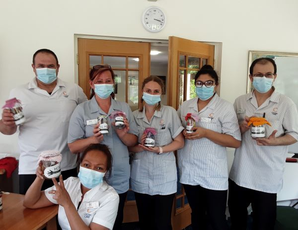 Team members at Woodpeckers with their ‘hug me’ jars.