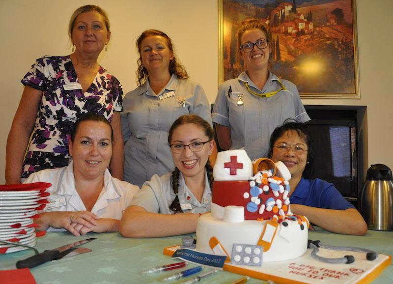 Kingfishers Home Manager Beata Brzozowska, standing left, with nurses at the New Milton Home. Chefs prepared a nursing themed cake to help mark Nurses' Day