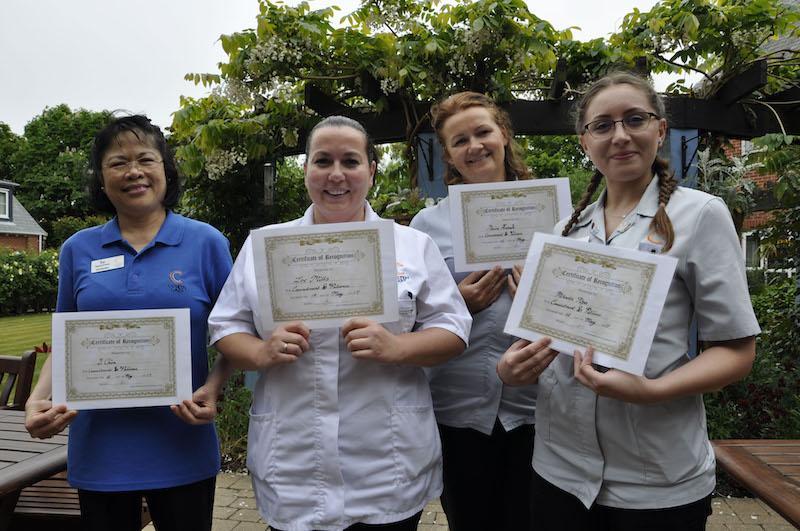 Nurses at Colten Care's New Milton Home, Kingfishers, hold their certificates of recognition on Nurses' Day. From left: Li Chiva, Zoe Mills, Monika Antosik and Mihaela Popa.
