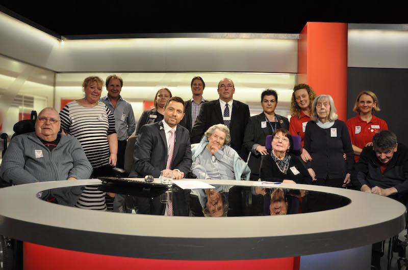 BBC South Today presenter Allen Sinclair, seated second from left, in the studio with residents and team members from Colten Care