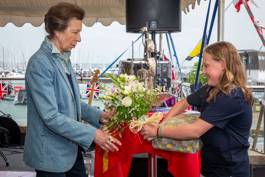 HRH The Princess Royal is presented with flowers and gifts by Ruby Coster