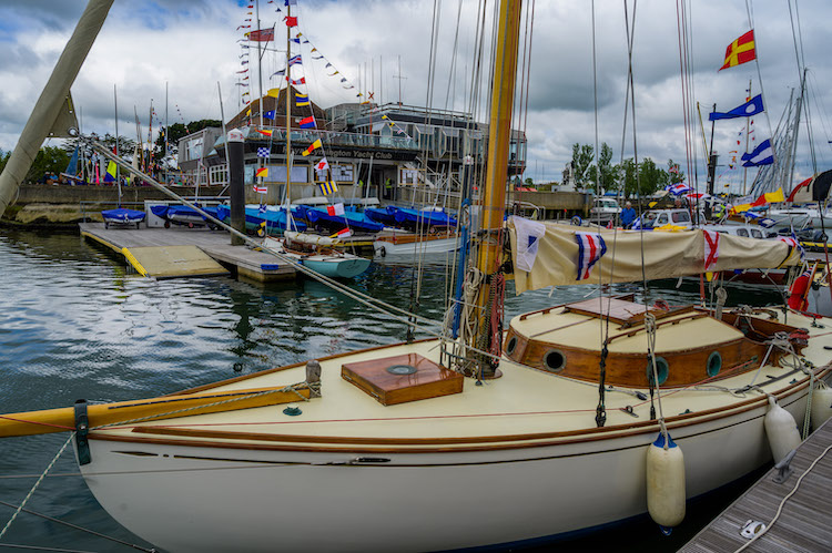 Vintage yacht dressed in front of the Royal Lymington Yacht Club