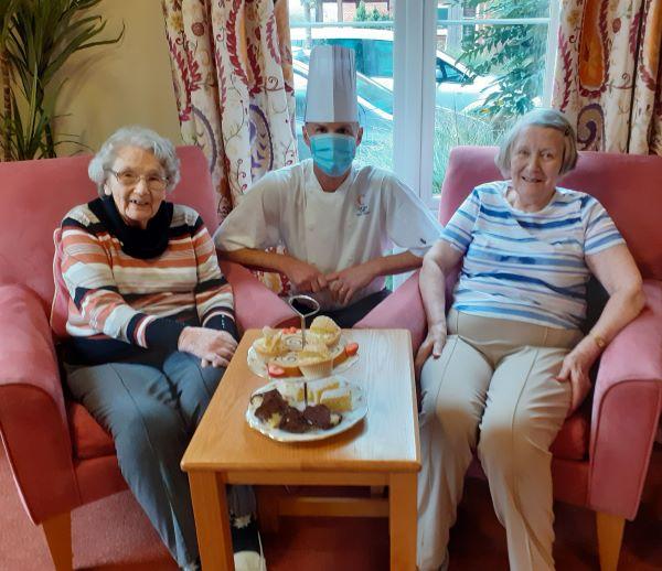 residents at care home with chef hat