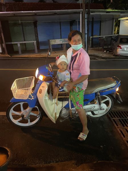 mother and baby on scooter in Thailand