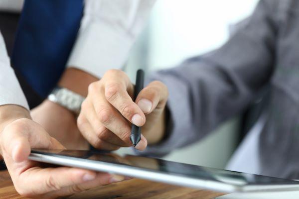 person signing online on laptop