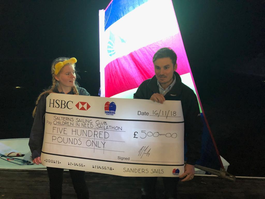 Christopher Sanders hands over a cheque for £500