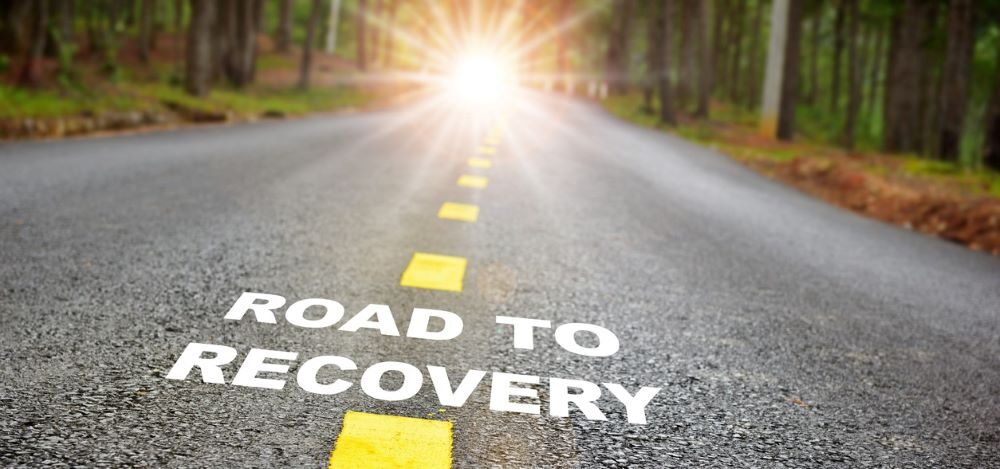 road to recovery with sun above