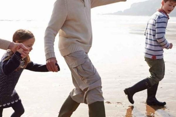 children with woman on beach