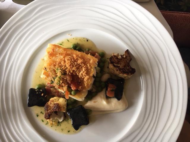 escapalope of day boat Cornish cod with squid ink gnocchi and a fricassee of pancetta, peas and spring onions