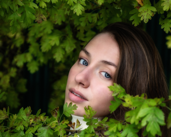 Woman between tree leaves